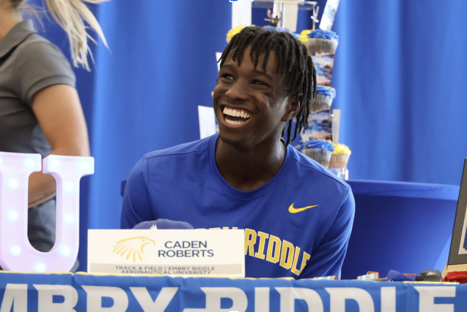 Senior Caden Roberts smiles while boys Track and Field Head Coach David Suarez gives his speech. Roberts will be continuing his academic and athletic career at Embry-Riddle Aeronautical University.

